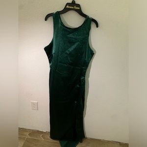 This an emerald green long dress with a slit on the side